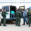 Border Patrol agents wear personal protective equipment as they take a group of migrants found near Sasabe back to Mexick, shortly after Customs and Border Protection began enforcing Title 42 in March 2020. (<a href="https://flic.kr/p/2iH5gqy" target="_blank" rel="noopener">Photo</a> by Jerry Glaser/<a href="https://www.flickr.com/photos/cbpphotos/" target="_blank" rel="noopener">Customs and Border Protection</a>)